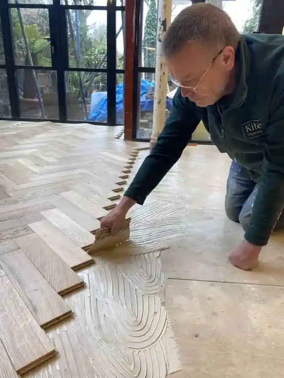 A man making Herringbone Hardwood Floors